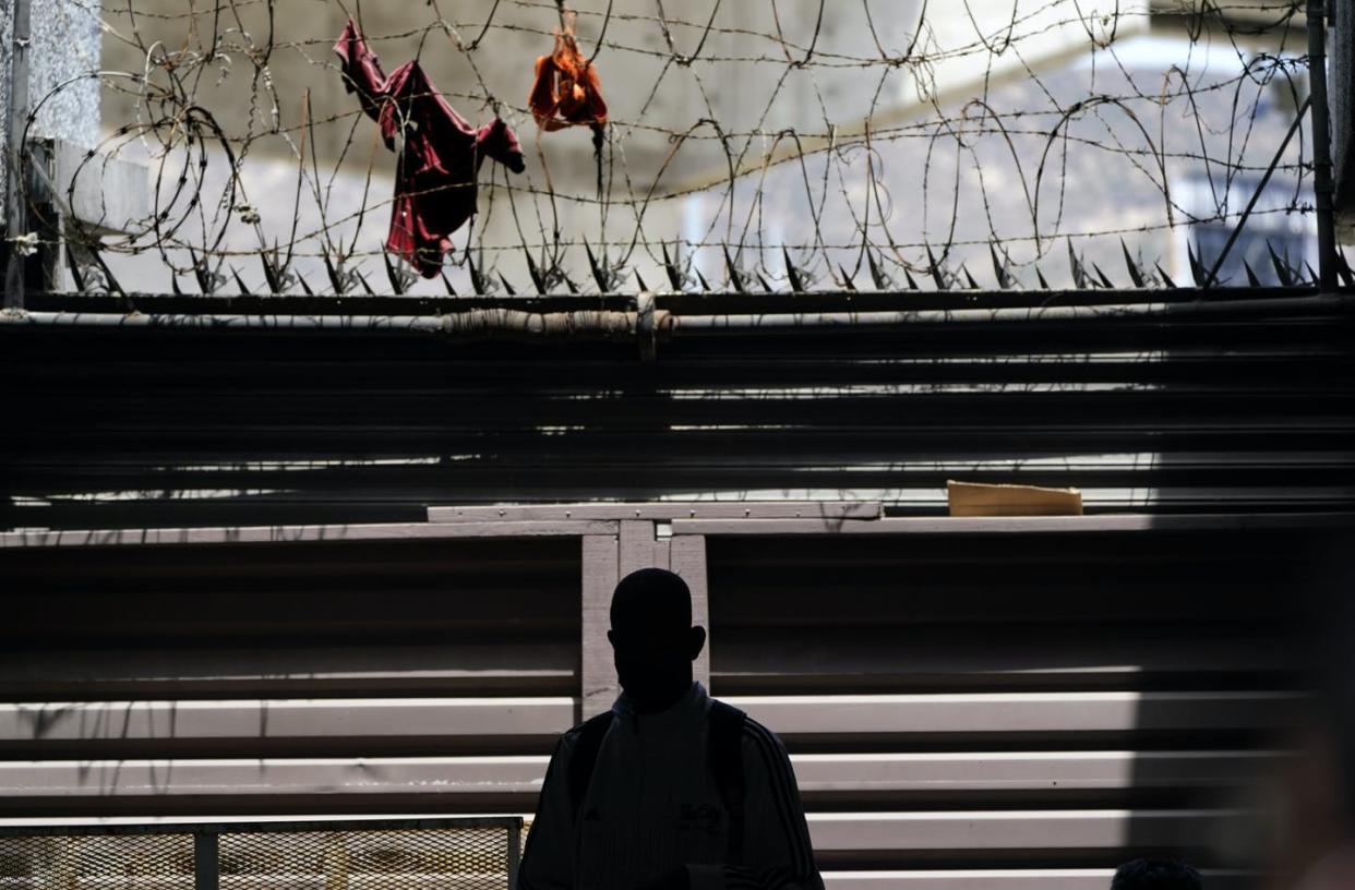 <span class="caption">A migrant from Haiti waits with others at a clinic for migrants in Tijuana, Mexico.</span> <span class="attribution"><a class="link " href="https://newsroom.ap.org/detail/SupremeCourtAsylumWaitinginMexico/14efcaea327c43fdbc163c1c38b84b70/photo?Query=%22remain%20in%20mexico%22&mediaType=photo&sortBy=arrivaldatetime:desc&dateRange=Anytime&totalCount=129&currentItemNo=0" rel="nofollow noopener" target="_blank" data-ylk="slk:AP Photo/Gregory Bull;elm:context_link;itc:0;sec:content-canvas">AP Photo/Gregory Bull</a></span>