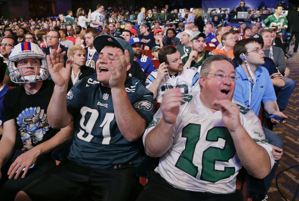 John Peniston, right, and his son, Sean, of Jamison, Pa., react to the announcement of the Philadelphia Eagles fourth-round selection at the 2014 NFL Draft, Saturday, May 10, 2014, in New York. The Eagles chose Florida cornerback Jaylen Watkins. (AP Photo/Julie Jacobson)