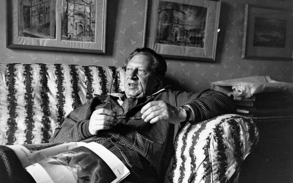 English author Sir Osbert Sitwell relaxing in his Derbyshire home