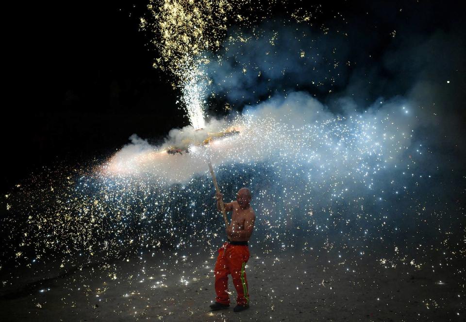 A performer takes part in a folk dance with firecrackers during the Lantern Festival in Shijiazhuang, Hebei province, China, on Feb. 5, 2023. 
