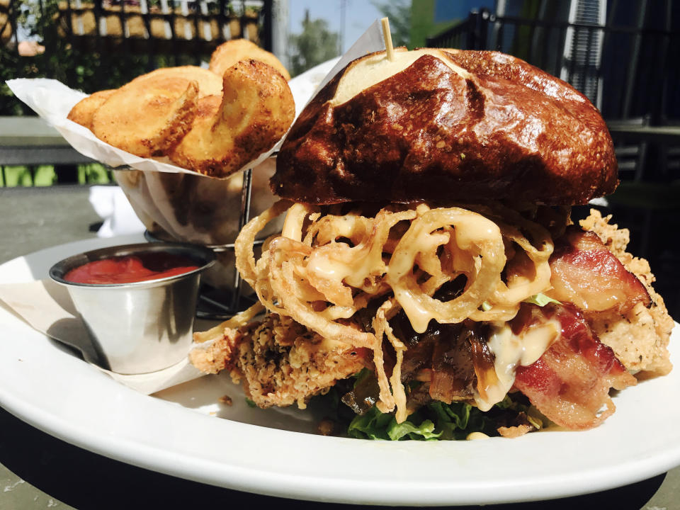 The South Bound Dump Truck, a fried chicken sandwich with lettuce, tomato, bacon, onion jam and Tabasco maple mayo on a pretzel bun. (Photo: Switch)