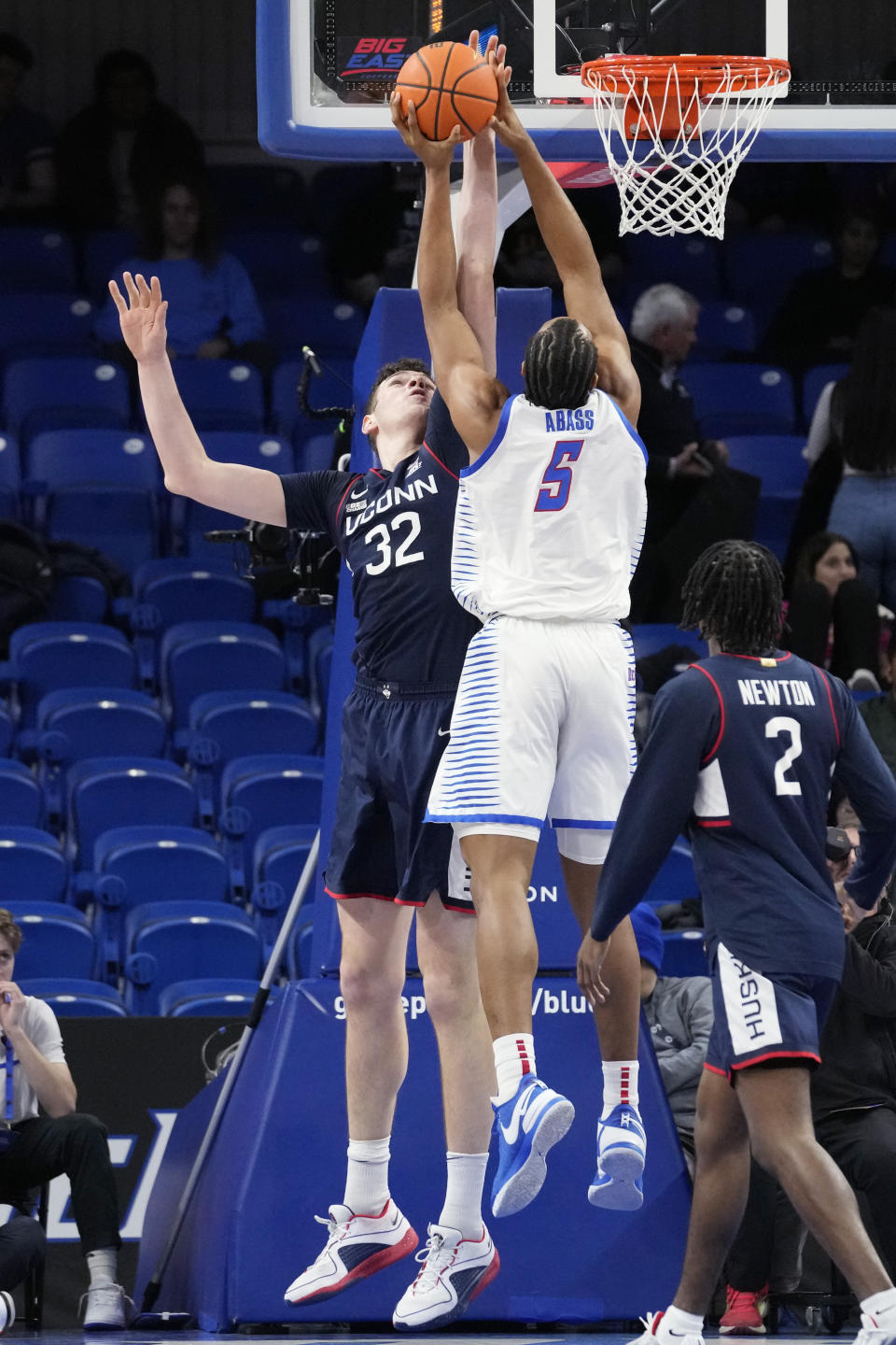 UConn center Donovan Clingan, left, blocks a shot by DePaul center Churchill Abass during the first half of an NCAA college basketball game in Chicago, Wednesday, Feb. 14, 2024. (AP Photo/Nam Y. Huh)