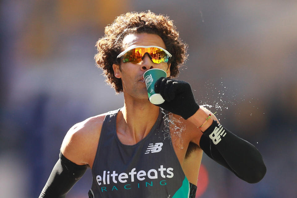 A runner drinks water during the 2019 New York City Marathon. (Photo: Gordon Donovan/Yahoo News)