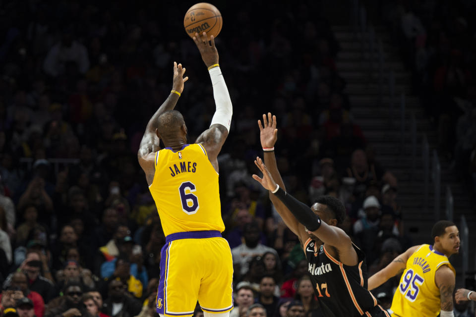 Los Angeles Lakers forward LeBron James (6) shoots a 3-point basket against Atlanta Hawks forward Onyeka Okongwu (17) during the second half of an NBA basketball game, Friday, Dec. 30, 2022, in Atlanta. (AP Photo/Hakim Wright Sr.)