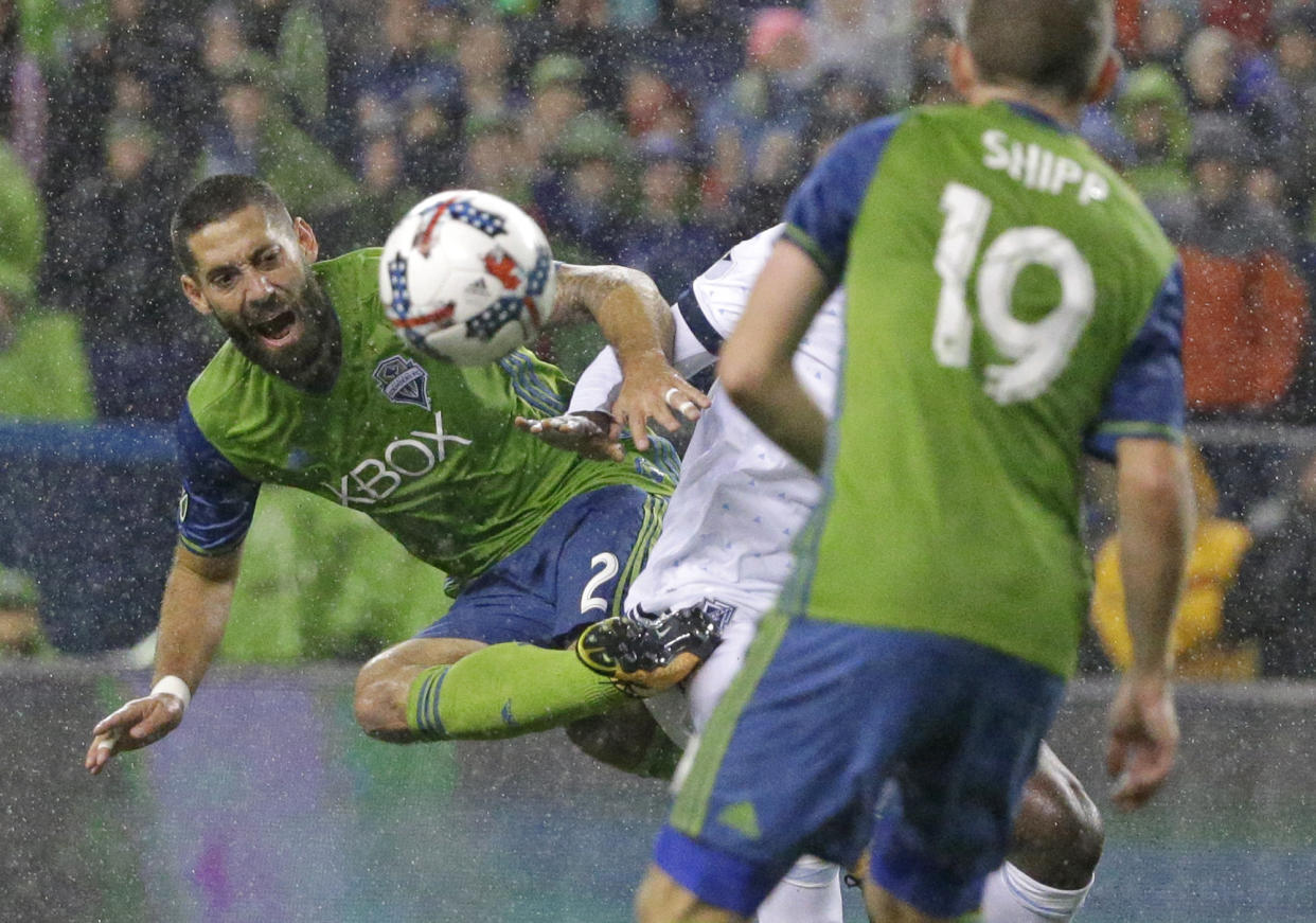 Seattle Sounders midfielder Clint Dempsey, left, kicks the ball away from Vancouver Whitecaps midfielder Aly Ghazal as Sounders’ Harrison Shipp (19) looks on during the first half of the second leg of an MLS soccer Western Conference semifinal, Thursday, Nov. 2, 2017, in Seattle. (AP Photo/Ted S. Warren)