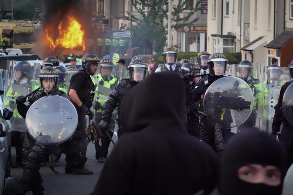 Riot police held back protesters after disorder broke out in Southport (Getty Images)