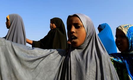 Zeinab, 14, (Rear C) stands in a daily morning queue to recite verses of the Koran and national songs before the beginning of class at the school for internally displaced people from drought hit areas in Dollow, Somalia April 4, 2017. REUTERS/Zohra Bensemra