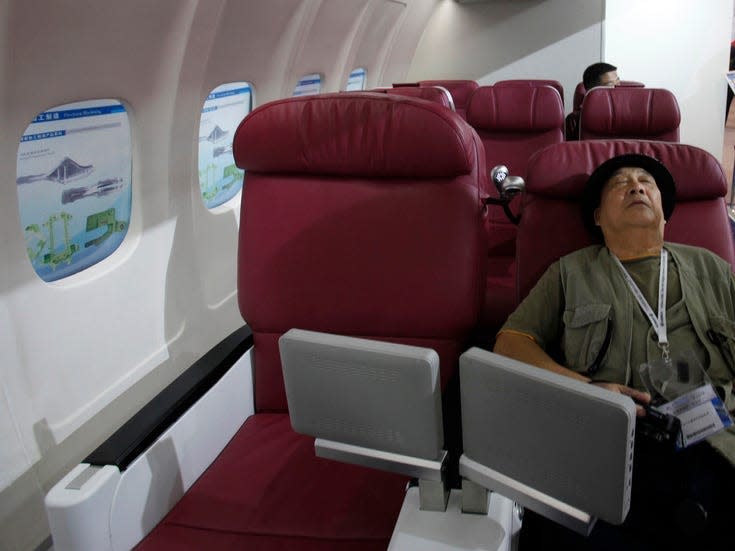 Person trying out the C919's business seat mcokup in 2012.