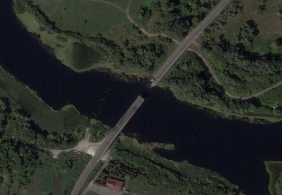 A broken Russian bridge spanning the border between two green areas, captured in a satellite image of the Kursk region.