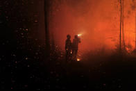 This photo provided by the fire brigade of the Gironde region (SDIS 33) shows firefighters working against a wildfire near Landiras, southwestern France, Saturday July 16, 2022. Firefighters are struggling to contain wildfires in France and Spain as Europe wilts under an unusually extreme heat wave that authorities link to a rise in excess mortality. (SDIS 33 via AP)