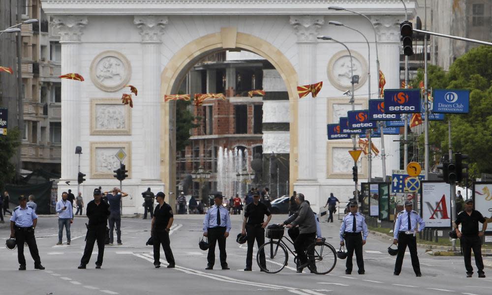 Police officers block the street in front of the parliament building in Skopje on Friday