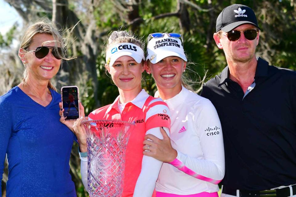 <p>Julio Aguilar/Getty</p> Nelly Korda and her family after winning the trophy at the Gainbridge LPGA in February 2021.