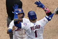 New York Mets' Javier Baez celebrates with Jonathan Villar after scoring the game winning run against the Miami Marlins during the ninth inning of the first game of a baseball doubleheader that started April 11 and was suspended because of rain, Tuesday, Aug. 31, 2021, in New York. The Mets won 6-5. (AP Photo/Adam Hunger)