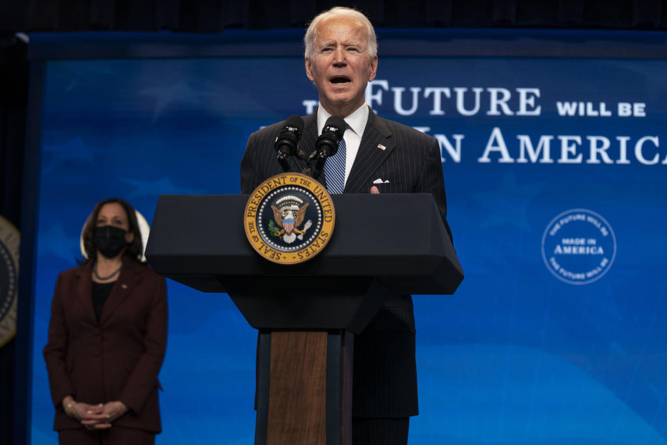 Vice President Kamala Harris listens as President Joe Biden speaks during an event on American manufacturing, in the South Court Auditorium on the White House complex, Monday, Jan. 25, 2021, in Washington. (AP Photo/Evan Vucci)