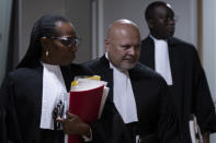 Public Prosecutor Karim Khan, centre, enters the court room for the trial of Mahamat Said Abdel Kani at the International Criminal Court in The Hague, Netherlands, Monday, Sept. 26, 2022. The trial of an alleged commander in a mainly Muslim rebel group from Central African Republic opened and charged Said with crimes against humanity and war crimes. (AP Photo/Peter Dejong, Pool)