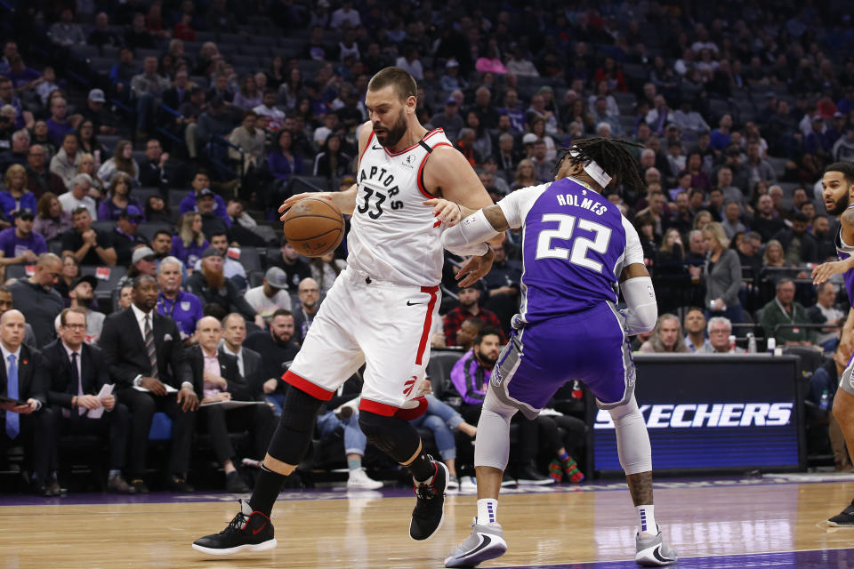 Toronto Raptors center Marc Gasol, left, tries to drive around Sacramento Kings center Richaun Holmes, right, during the first quarter of an NBA basketball game in Sacramento, Calif., Sunday, March 8, 2020. (AP Photo/Rich Pedroncelli)