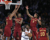 New York Knicks forward Julius Randle, center, is defended by Cleveland Cavaliers forward Evan Mobley, left to right, forward Mamadi Diakite, forward Lamar Stevens and guard Darius Garland during the first half of an NBA basketball game, Sunday, Dec. 4, 2022, in New York. (AP Photo/John Munson)