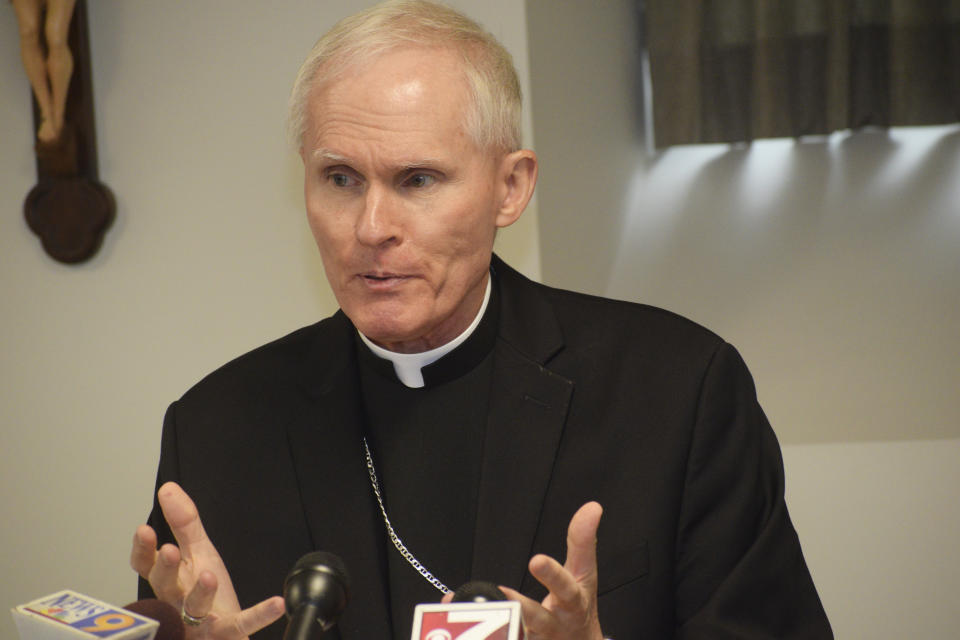 FILE - In this July 23, 2019 file photo Bishop Mark Brennan announces his appointment to serve as bishop of the Diocese of Wheeling-Charleston, during a news conference in Wheeling, W.Va. A lawsuit accusing the former bishop of West Virginia’s Roman Catholic diocese of molesting boys and men has been settled. The terms of the recent settlement are confidential, Wheeling-Charleston Diocese spokesman Tim Bishop said in a statement. His replacement, Baltimore Auxiliary Bishop Mark Brennan, is set to be installed Thursday, Aug. 22, 2019 in Wheeling. (Scott McCloskey/The Intelligencer via AP, file)