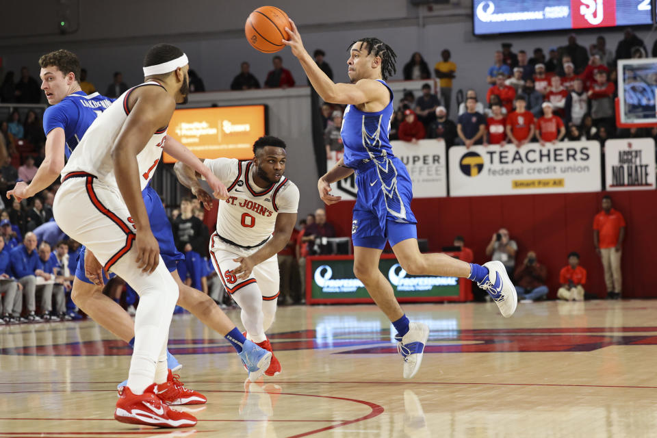 Creighton guard Ryan Nembhard passes the ball as St. John's guard Posh Alexander (0) and center Joel Soriano defend as Creighton center Ryan Kalkbrenner runs forward during the first half of an NCAA college basketball game Saturday, Feb. 18, 2023, in New York. (AP Photo/Jessie Alcheh)