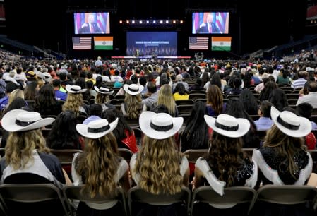 People listen to U.S. President Donald Trump as they attend the "Howdy Modi" event in Houston