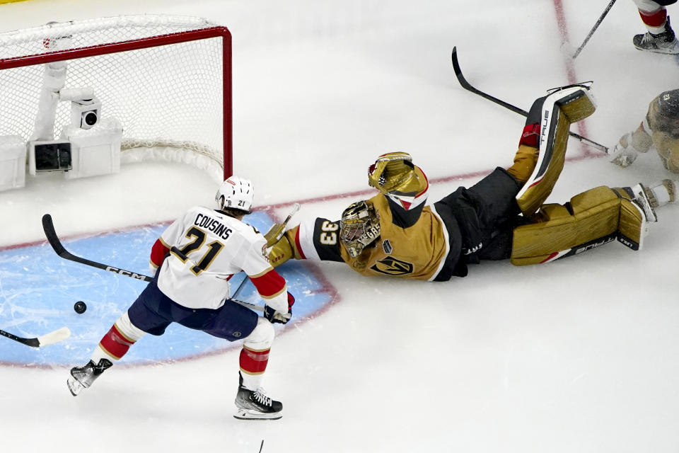 Vegas Golden Knights goaltender Adin Hill (33) blocks a shot on goal by Florida Panthers center Nick Cousins (21) during the second period of Game 1 of the NHL hockey Stanley Cup Finals, Saturday, June 3, 2023, in Las Vegas. (AP Photo/John Locher)