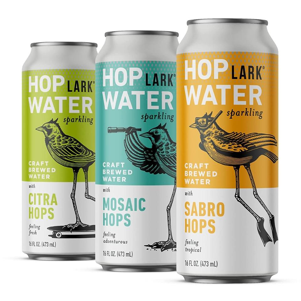 Three cans of hops water in green, turquoise, and yellow
