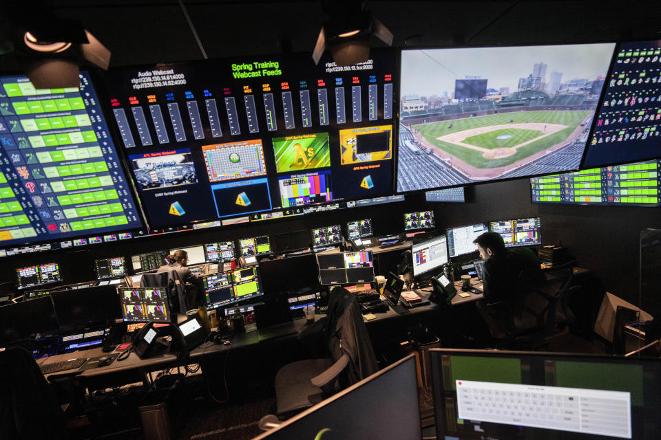 Employees are shown at workstations during a tour inside the broadcast support room at Major League Baseball headquarters in New York, Tuesday, March 28, 2023. (AP Photo/John Minchillo)