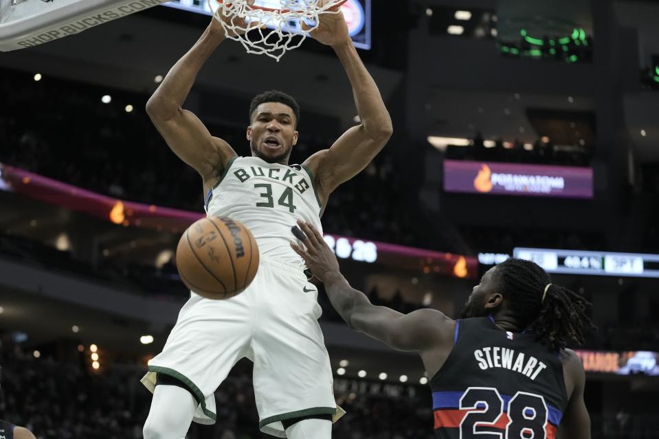 Milwaukee Bucks' Giannis Antetokounmpo dunks over Detroit Pistons' Isaiah Stewart during the second half of an NBA basketball game Wednesday, Nov. 2, 2022, in Milwaukee. The Bucks won 116-91. (AP Photo/Morry Gash)