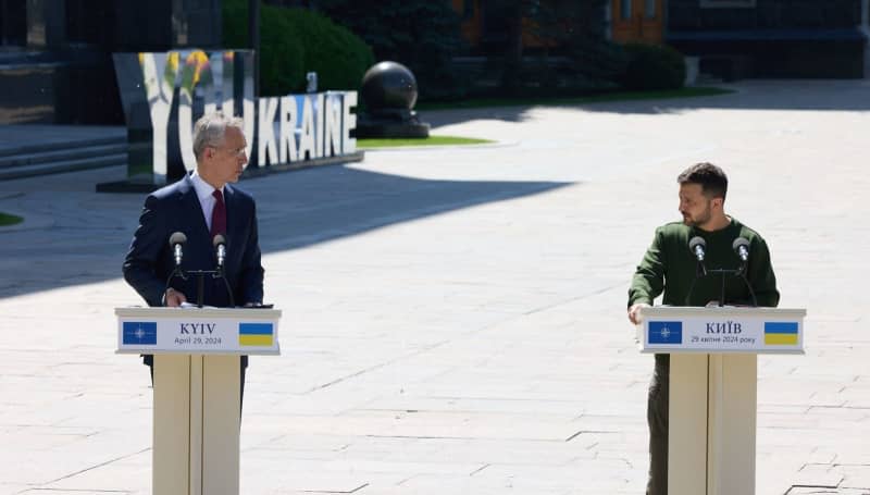 NATO Secretary General Jens Stoltenberg and President Volodymyr Zelenskyy of Ukraine attend a joint press conference. "The lack of ammunition has enabled the Russians to push forward along the front line," Stoltenberg said, singling out the United States for Washington's protracted process to send more military aid. -/NATO/dpa