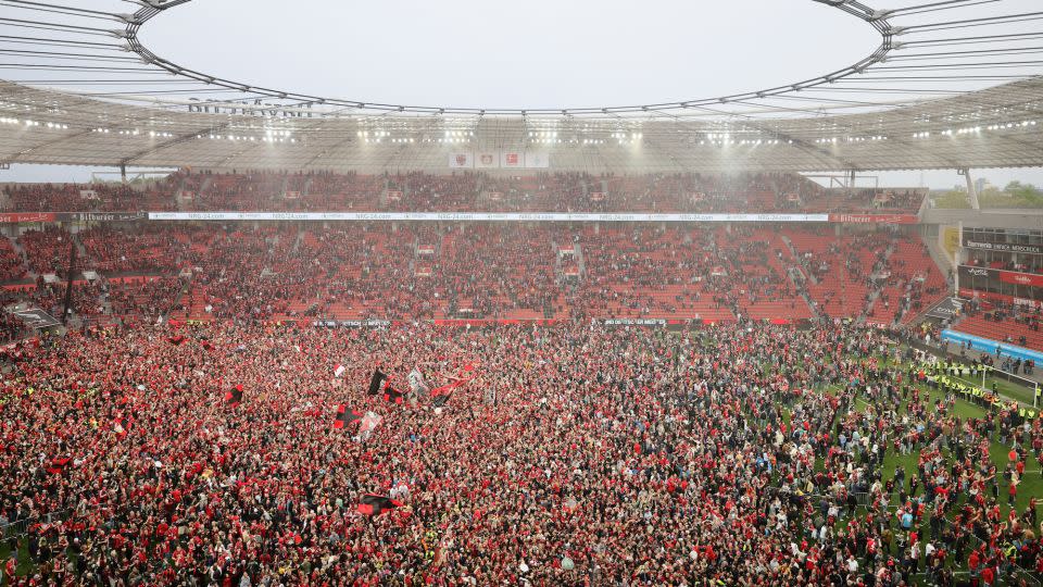 Leverkusen fans celebrated en masse on the pitch after winning the German league title. - Andreas Rentz/Getty Images