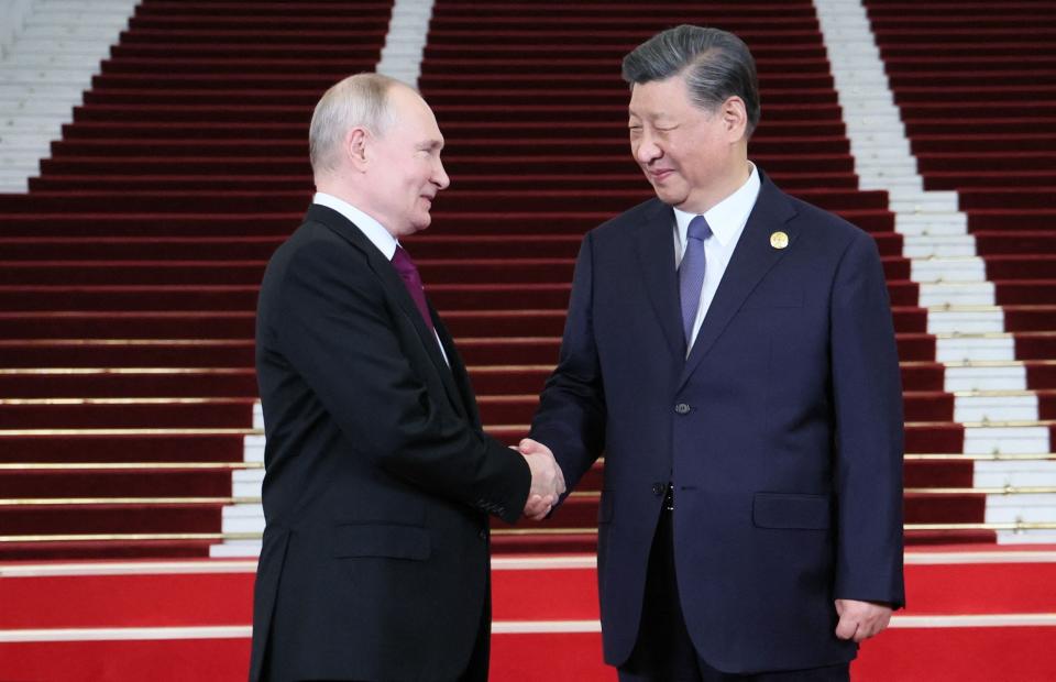 Russian President Vladimir Putin greets Chinese President Xi Jinping in Beijing on Oct. 17, 2023.