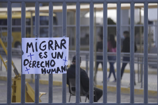 The Spanish message "To migrate is a human right" hangs on the fence outside the Mexican immigration detention center that was the site of a deadly fire in Ciudad Juarez, Mexico, Thursday, March 30, 2023. (AP Photo/Fernando Llano)