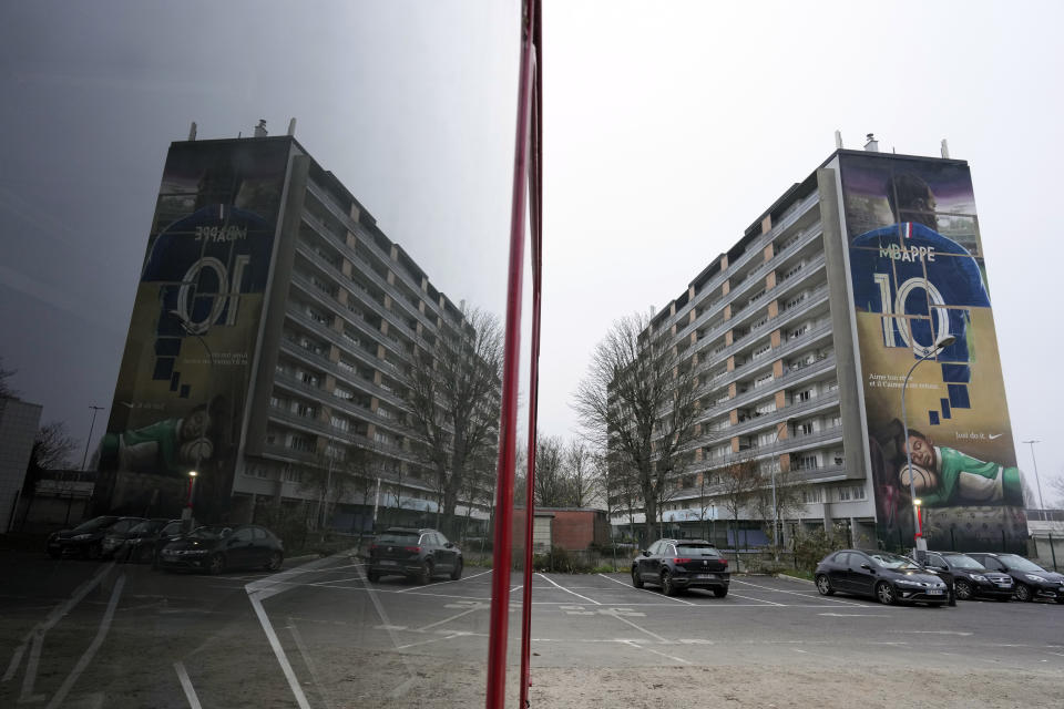 A wall mural representing France national team soccer player Kylian Mbappe is seen in his hometown of Bondy, east of Paris, Saturday, Dec. 17, 2022. (AP Photo/Thibault Camus)