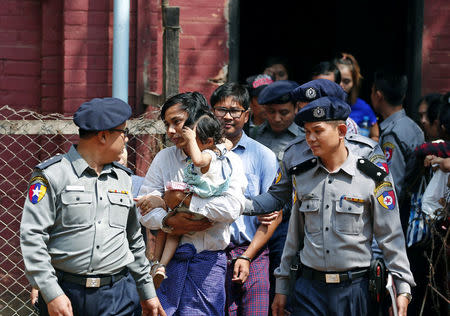 Detained Reuters journalist Kyaw Soe Oo and Wa Lone are escorted by police while arriving for a court hearing after lunch break in Yangon, Myanmar February 14, 2018. REUTERS/Stringer