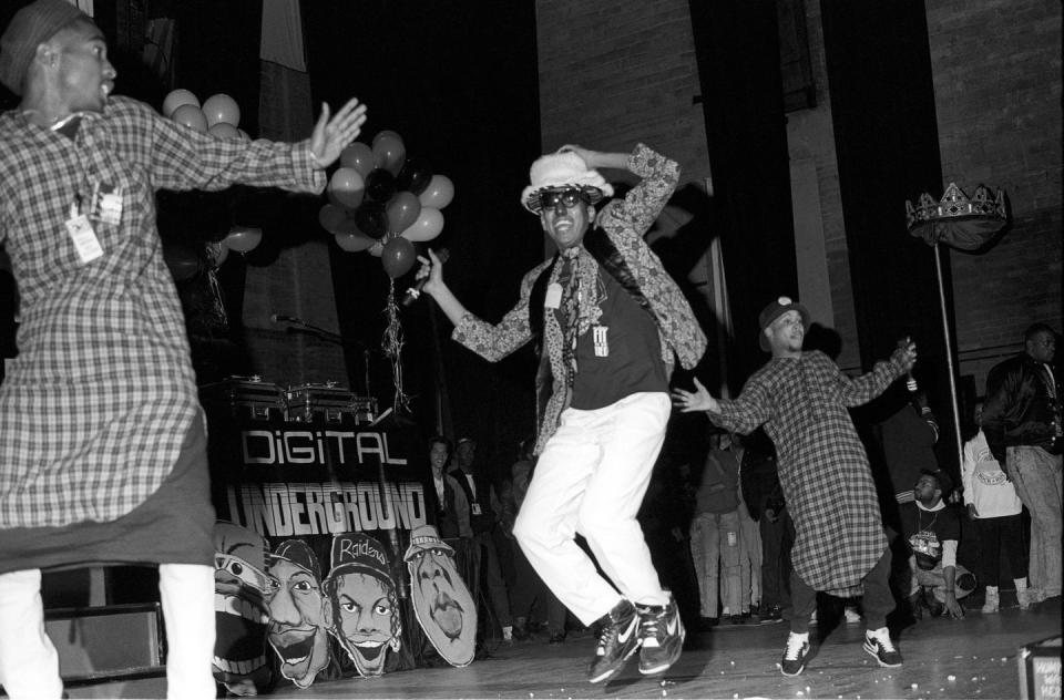 <p>Tupac Shakur, Shock G, Money-B, and Digital Underground at Newark Symphony Hall on April 10, 1990 in New Jersey.</p>