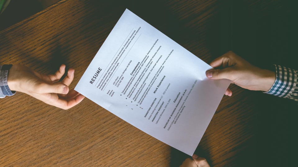 top overhead directly above view of employee hiring person and examine the resume on the office table.