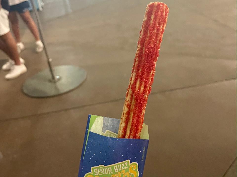 hand holding spicy churro at oogie boogie bash in disneyland