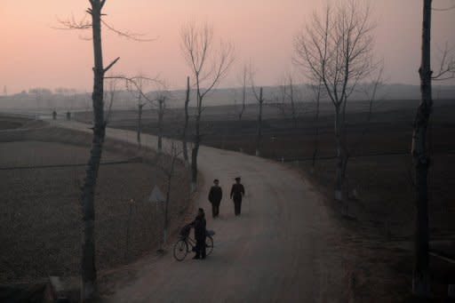 North Koreans are seen from the window of a train along the railway line between Pyongyang and North Phyongan Province on the west coast on April 8, 2012. illions of North Koreans suffer chronic food shortages and dire health care, leaving one in three young children stunted, and there are no immediate signs of reforms to spur economic growth, the United Nations says