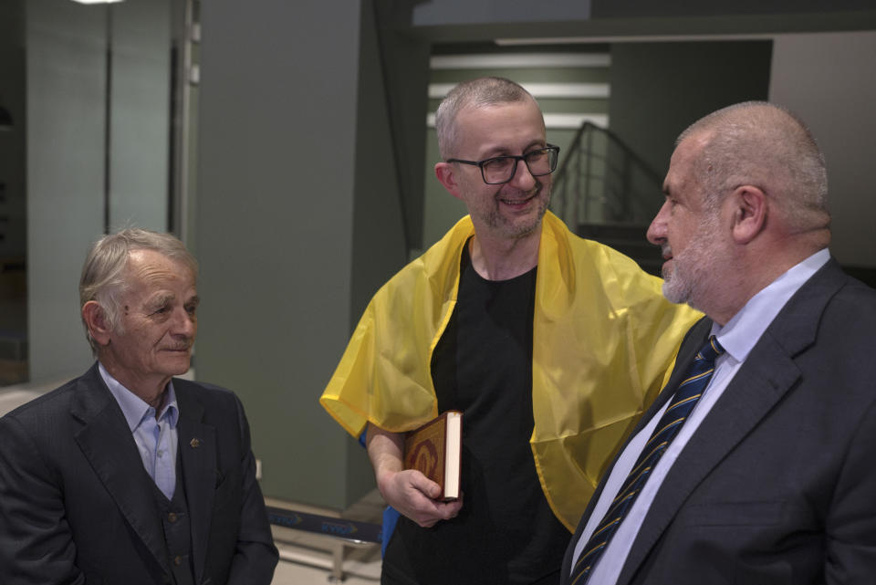 Nariman Dzhelyal, deputy head of the Mejlis of the Crimean Tatar People, center, in Kyiv airport, Ukraine, Saturday, June 29, 2024. Ten Ukrainians who had been held prisoners for years, were released from Russian captivity on Friday with a mediation of Vatican, said Ukraine's President Volodymyr Zelenskyy. Among the freed was Deputy Head of the Mejlis Nariman Dzhelyal. Mejlis is a representative body of Crimean Tatars that was relocated to Kyiv after Russia seized Crimea.(AP Photo/Alex Babenko)