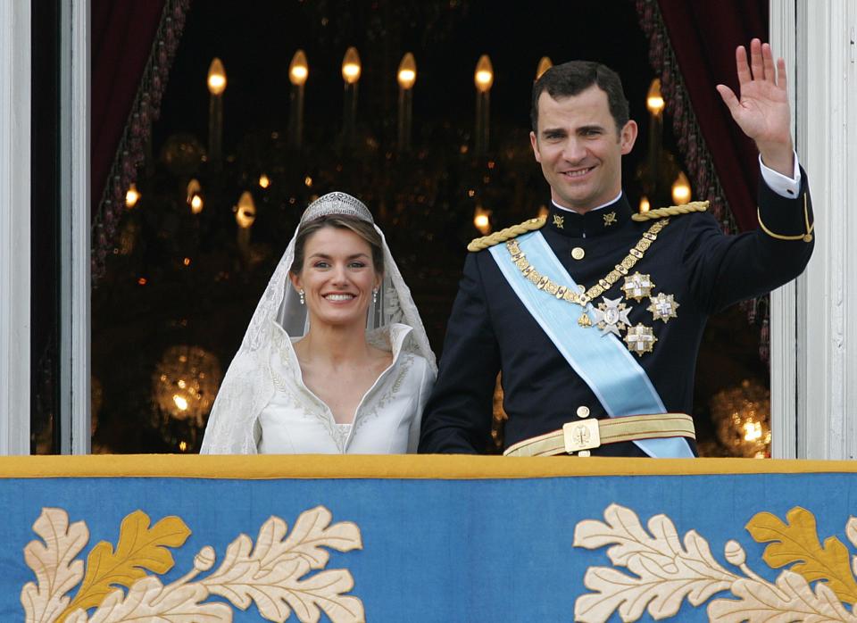 Princess of Asturias Letizia Ortiz and her husband Spanish Crown Prince Felipe of Bourbon smile as they wave to the crowd from the balcony of the Oriental Palace after their wedding in Madrid 22 May 2004. AFP PHOTO CHRISTOPHE SIMON        (Photo credit should read CHRISTOPHE SIMON/AFP via Getty Images)