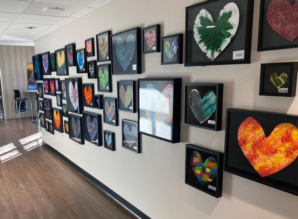 The newly renovated Ronald McDonald Charity House is decorated with artwork. Here, a hallway is decorated with hearts of unique colors and sizes.