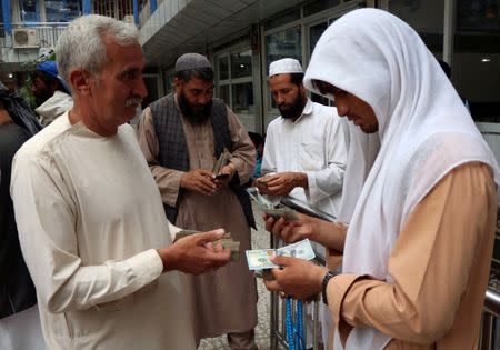 Afghan money changers gather to deal with foreign currency at a money change market in Herat province, Afghanistan June 3, 2018. Picture taken June 3, 2018. REUTERS/Jalil Ahmad