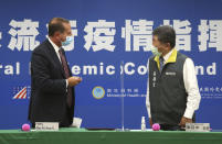 U.S. Health and Human Services Secretary Alex Azar, left, greets Taiwanese Minister of Health and Welfare Chen Shih-chung after the signing ceremony for a memorandum of understanding at the Central Epidemic Command Center in Taipei, Taiwan, Monday, Aug. 10, 2020. Azar arrived in Taiwan on Sunday in the highest-level visit by an American Cabinet official since the break in formal diplomatic relations between Washington and Taipei in 1979. (AP Photo/Chiang Ying-ying)