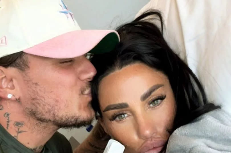 Katie Price being kissed on the head by her boyfriend in a selfie