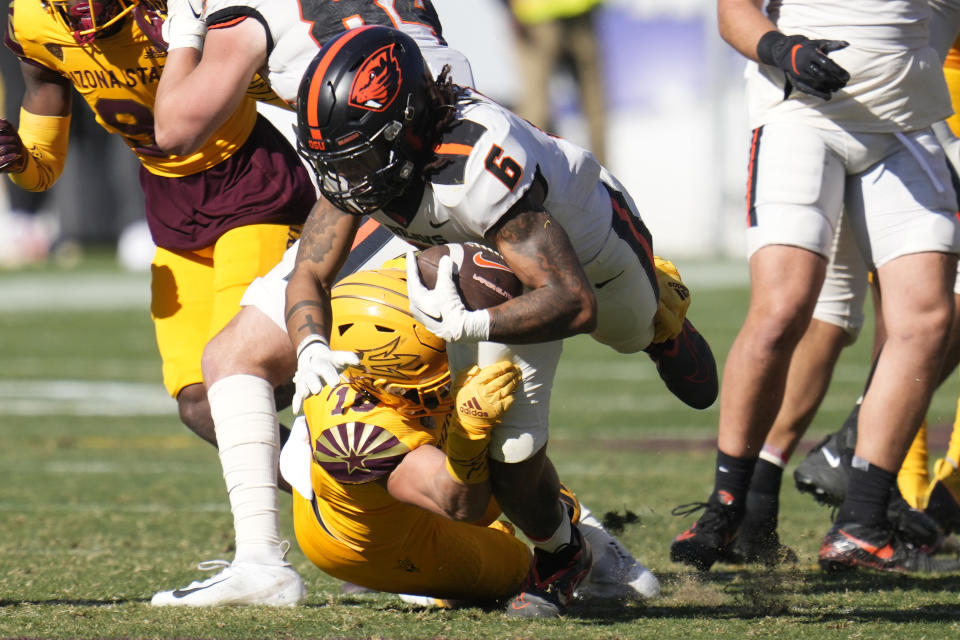 Oregon State running back Damien Martinez (6) gets tackled by Arizona State linebacker Connor Soelle during the second half of an NCAA college football game in Tempe, Ariz., Saturday, Nov. 19, 2022. Oregon State won 31-7. (AP Photo/Ross D. Franklin)