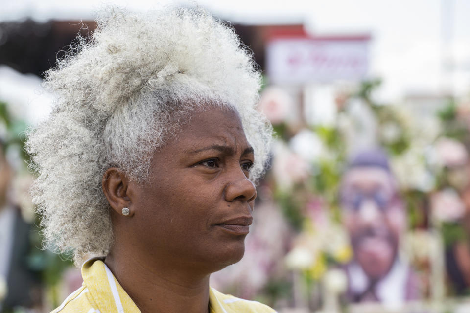 Cariol Horne, 54, stands near a memorial for the victims of the supermarket shooting outside the Tops Friendly Market on Thursday, July 14, 2022, in Buffalo, N.Y. (AP Photo/Joshua Bessex)