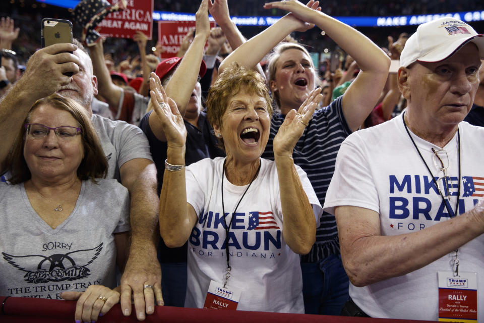 Supporters of President Donald Trump cheer as he arrives for a campaign rally at the Ford Center, Thursday, Aug. 30, 2018, in Evansville, Ind. (AP Photo/Evan Vucci)