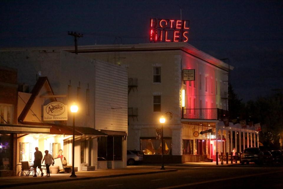 A couple walks down Main Street near the Niles Hotel in Alturas, Calif., on May 17, 2023.