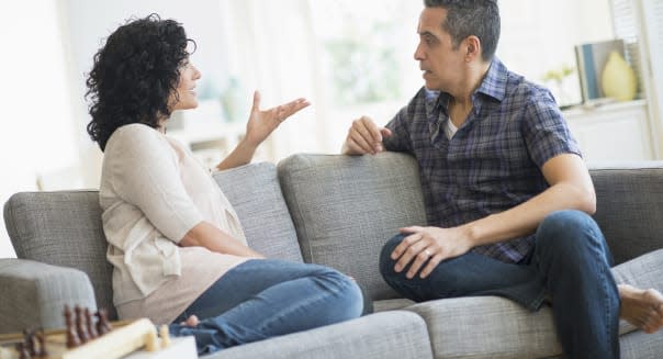 USA, New Jersey, Jersey City, Couple talking on sofa