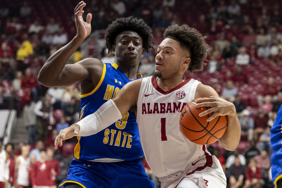Alabama guard Mark Sears (1) fights past Morehead State guard Drew Thelwell (3) during the first half of an NCAA college basketball game, Monday, Nov. 6, 2023, in Tuscaloosa, Ala. (AP Photo/Vasha Hunt)